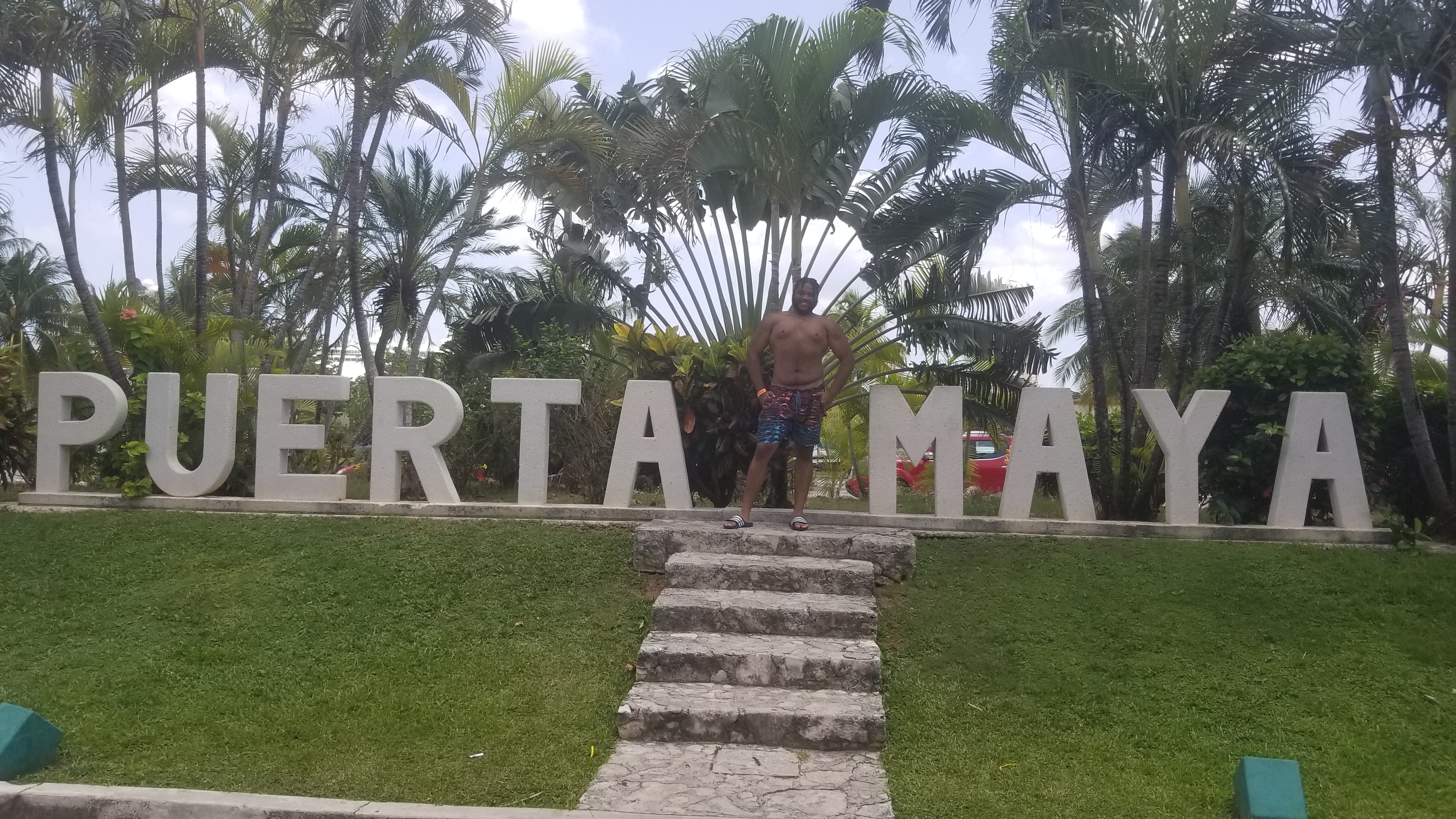 justin in front of puerta maya sinage